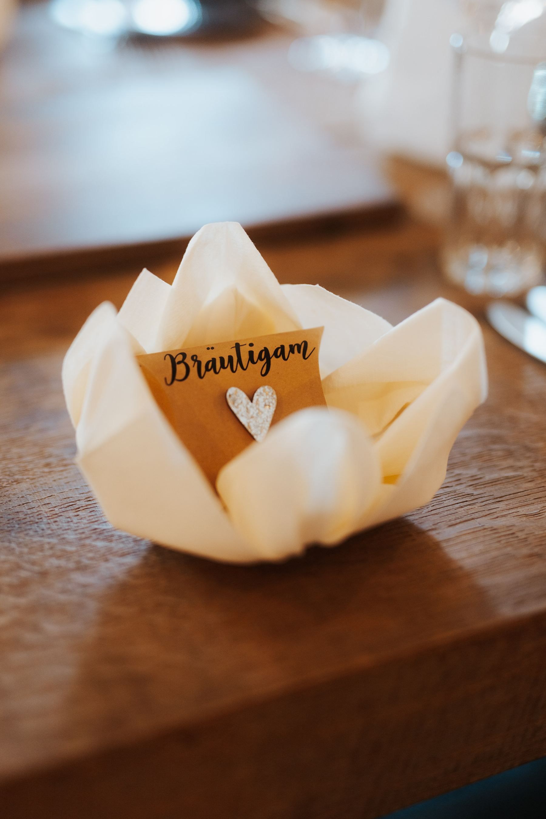 Place card reading “Bräutigam” (groom) on a laid wedding table