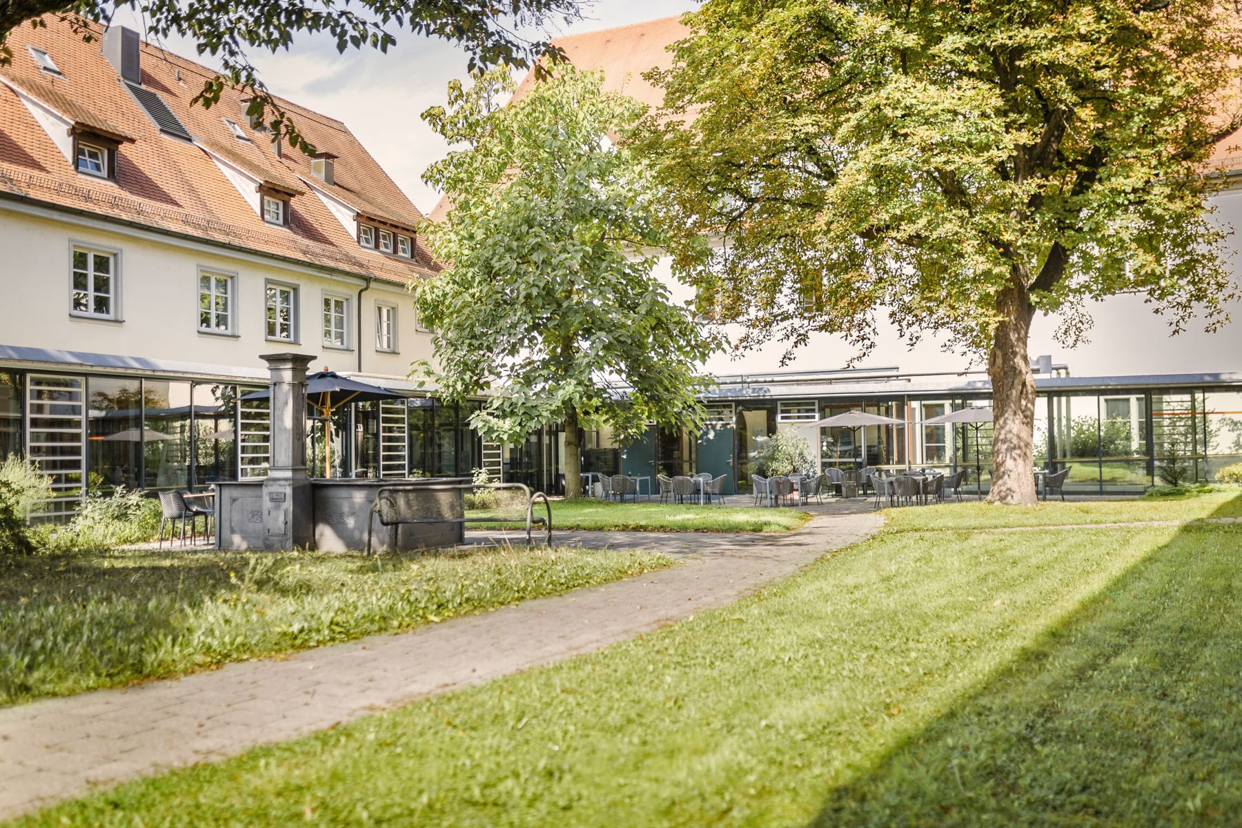 Green Spital garden with a large tree in the historic Spital