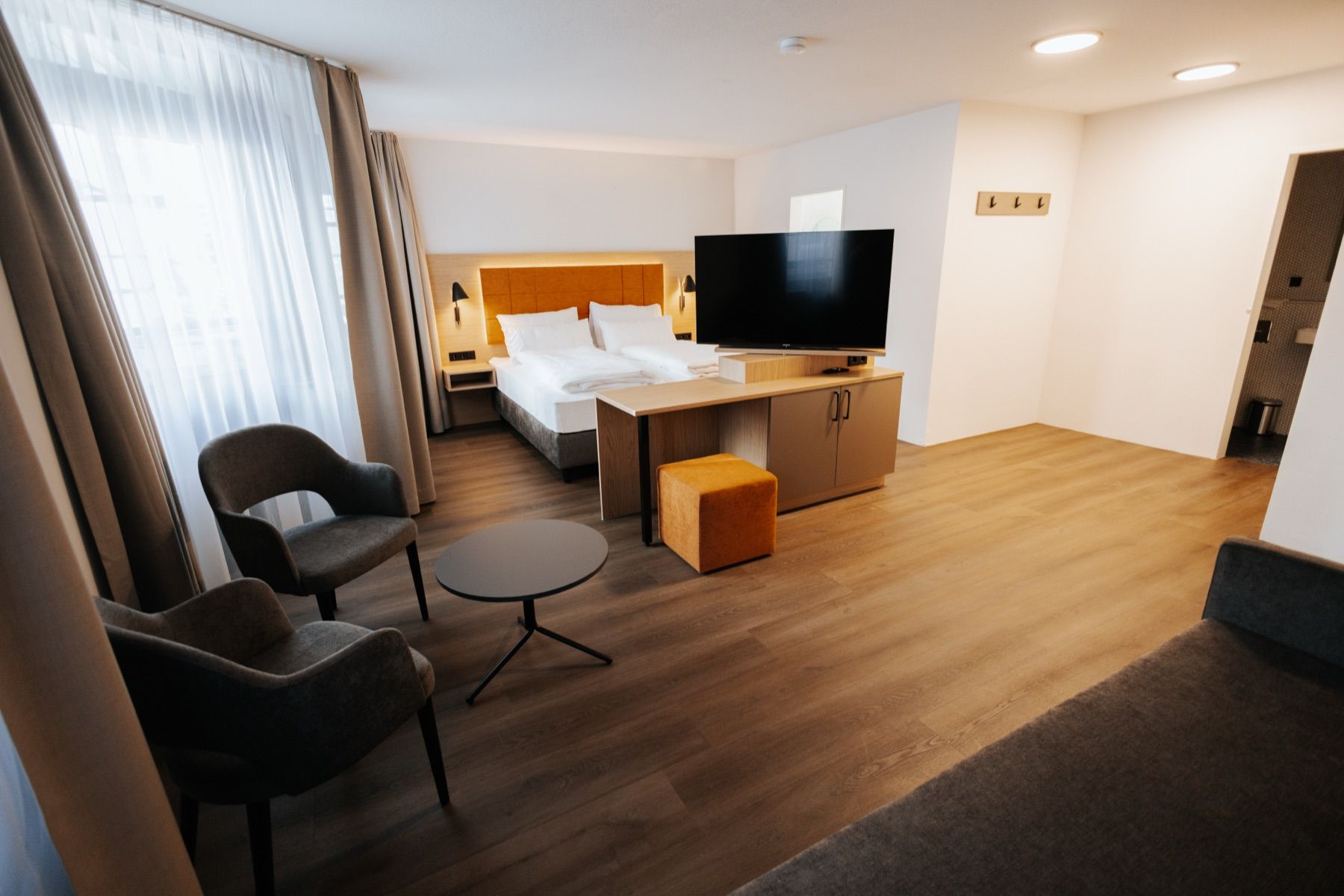 Suite with double bed, seating area and TV