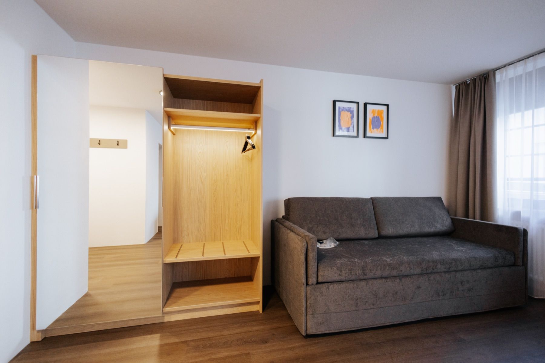 Suite with sofa and open wardrobe